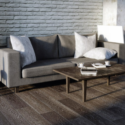 Living room with grey couch and table on laminate flooring