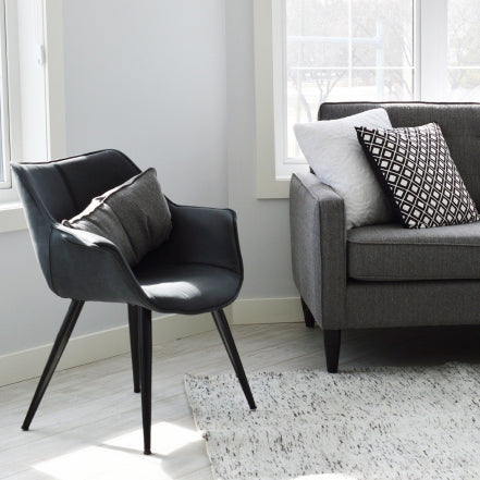 Living room with a chair and couch with rug on the floor