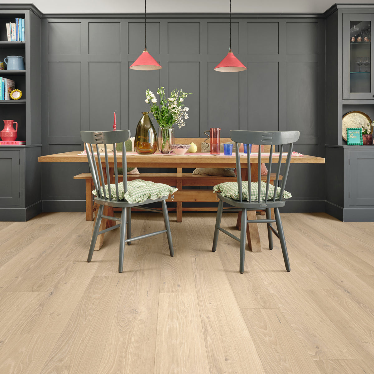 Dining room with wooden table, chairs, and gray walls.